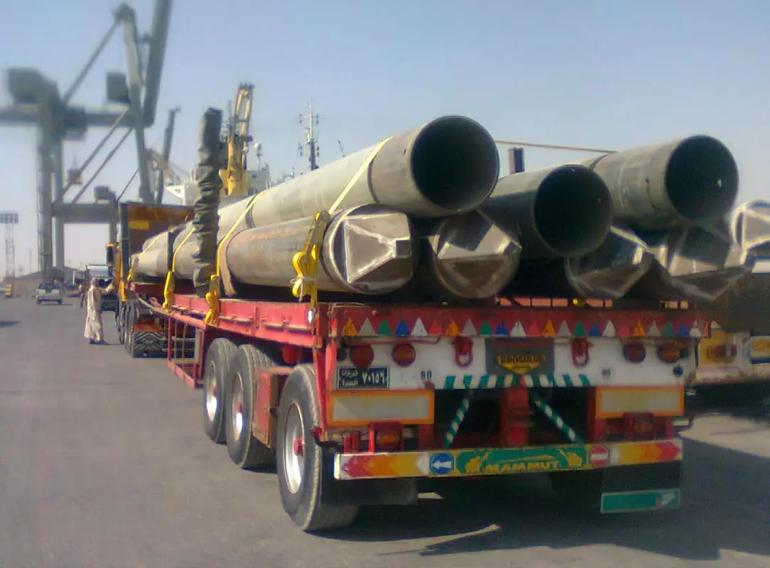 Truck carrying large industrial pipes